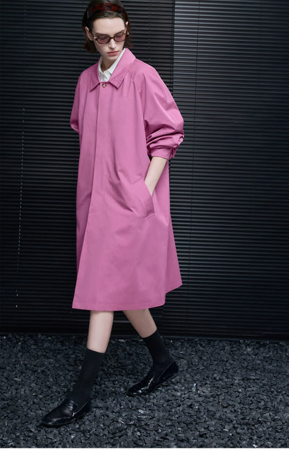 Orchid Pink A-line cotton coat in motion, showing the concealed placket and wide raglan sleeves