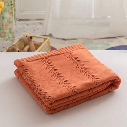 Folded Orange Oversize Knit Throw Blanket showing soft cotton knit texture and ribbed edges