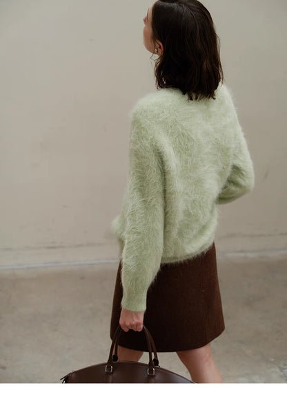 Honeydew green alpaca sweater back view showing soft fluffy texture, long sleeves and relaxed oversized fit from rear angle