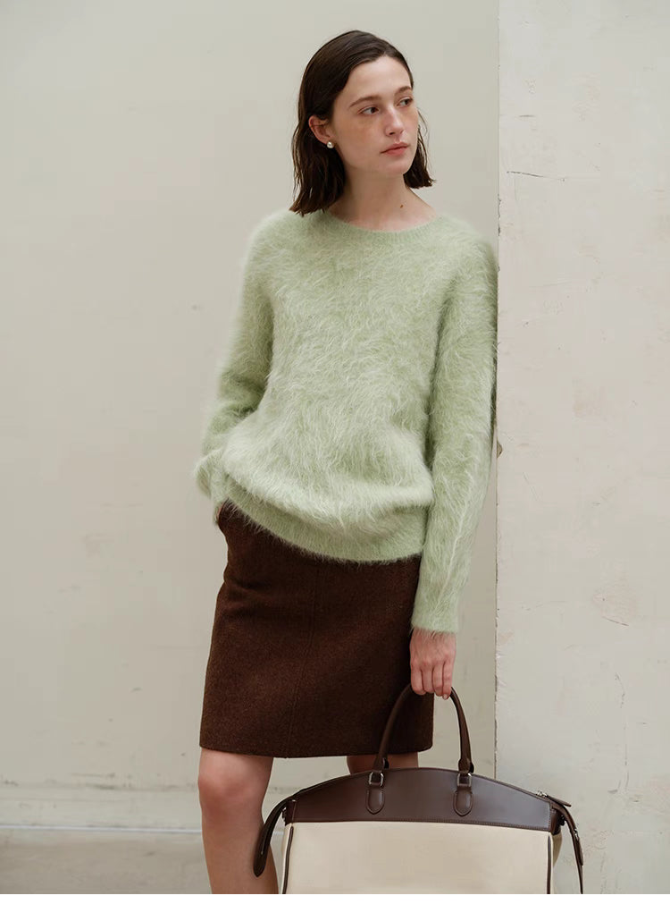 Honeydew green oversized alpaca sweater full body styling with skirt and handbag, showing outfit pairing and relaxed silhouette