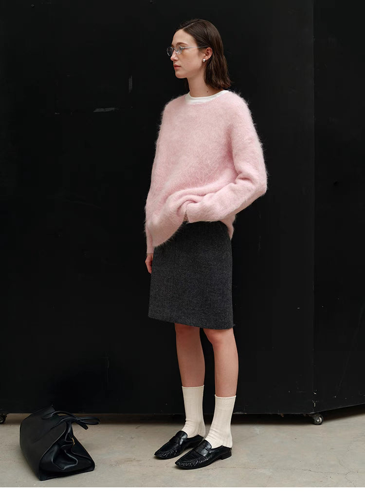 Pink oversized alpaca sweater side profile while standing, highlighting silhouette, hip-length cut and soft brushed texture