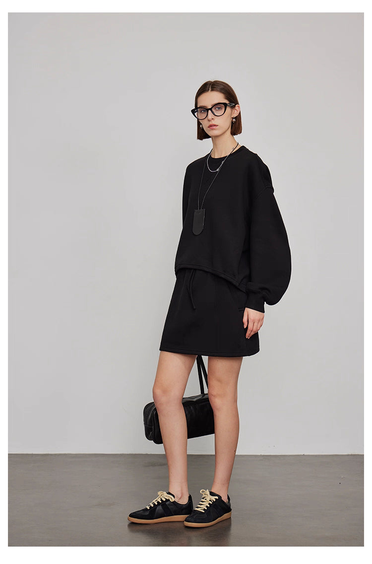 Back view of women’s oversized sweatshirt and wide-leg pants lounge set in gray