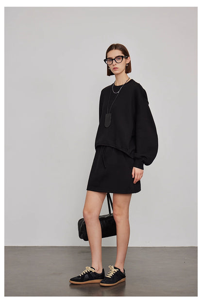 Back view of women’s oversized sweatshirt and wide-leg pants lounge set in gray