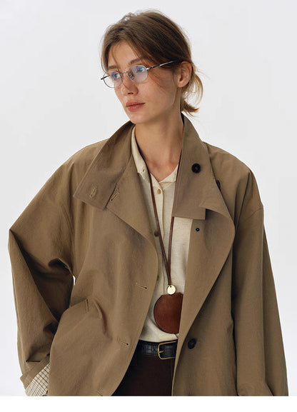 Close-up of convertible collar and horn buttons on salt-shrunk trench jacket