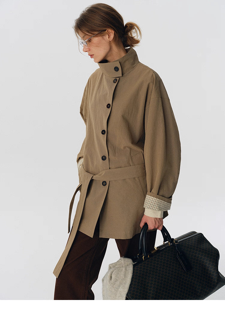 Belted side profile of salt-shrunk trench jacket in palm khaki