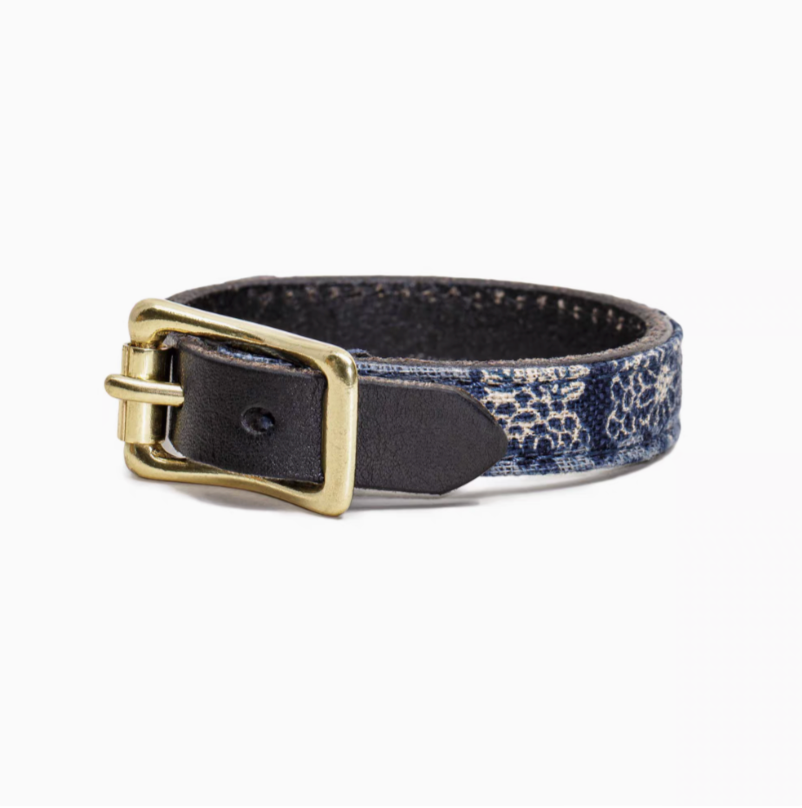 Patchwork leather bracelet in black and navy blue with brass buckle displayed in product view