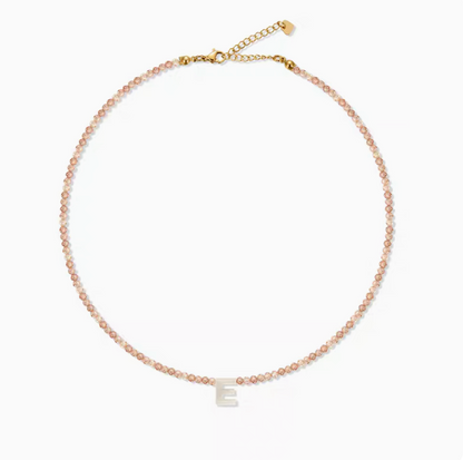 Natural color personalized shell initial necklace with letter E charm on delicate beaded chain product view
