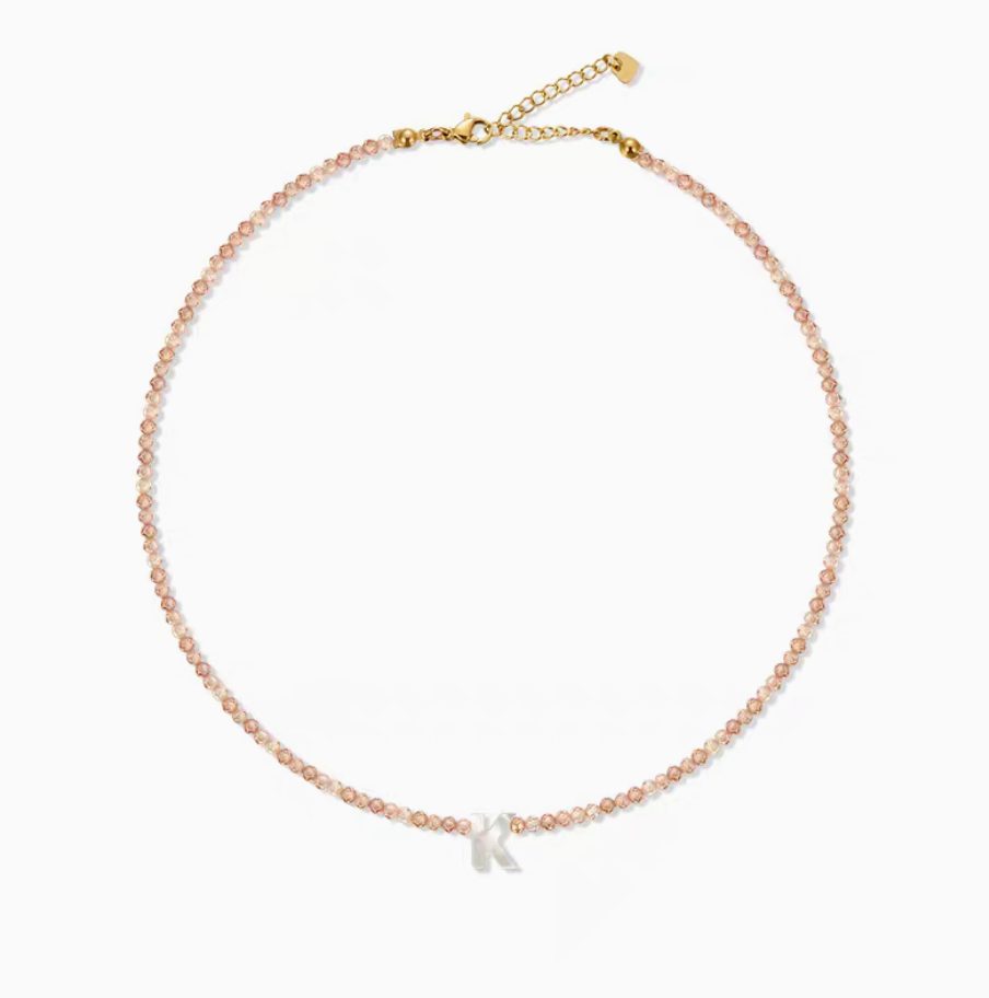 Natural color personalized shell initial necklace with letter K charm on delicate beaded chain clean product display