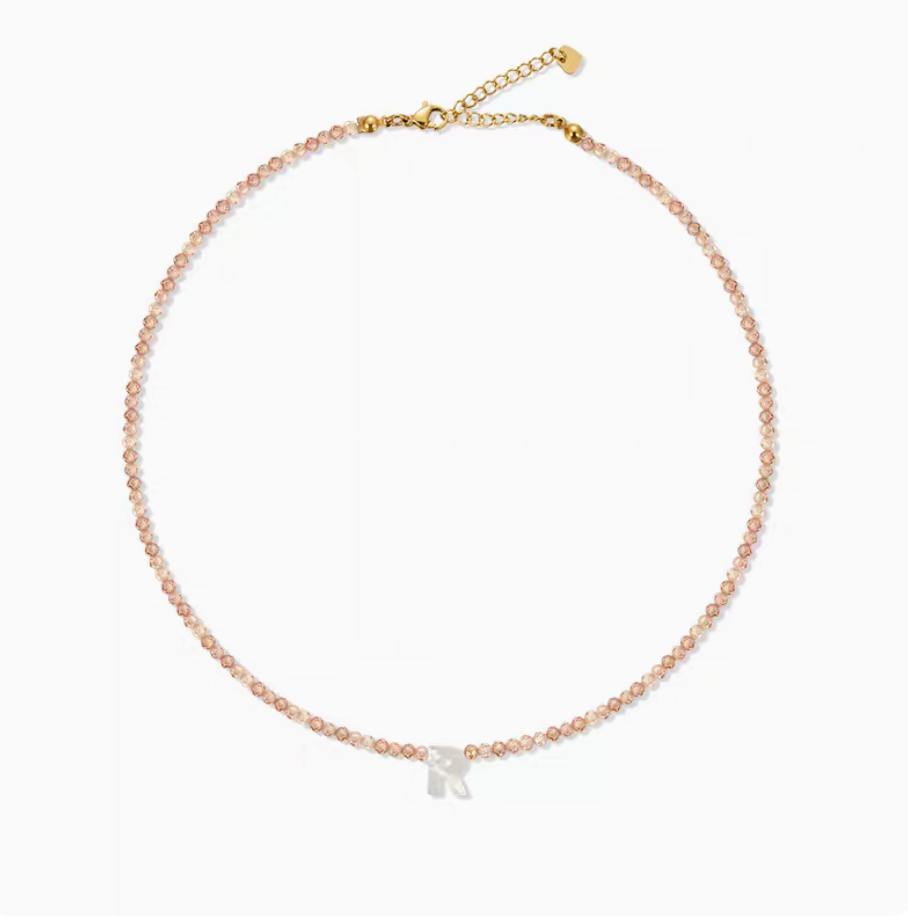 Personalized shell initial necklace featuring letter R charm on natural bead chain simple product display
