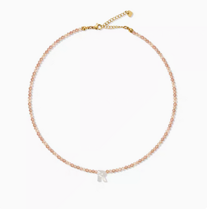 Personalized shell initial necklace featuring letter R charm on natural bead chain simple product display