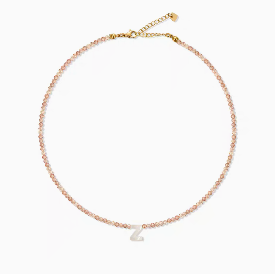 Personalized shell initial necklace with letter Z charm on natural stone beaded chain clean product display