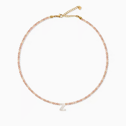 Personalized shell initial necklace with letter Z charm on natural stone beaded chain clean product display