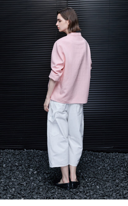 Back view of a Pink boxy linen jacket showing the hip-length hem and band collar