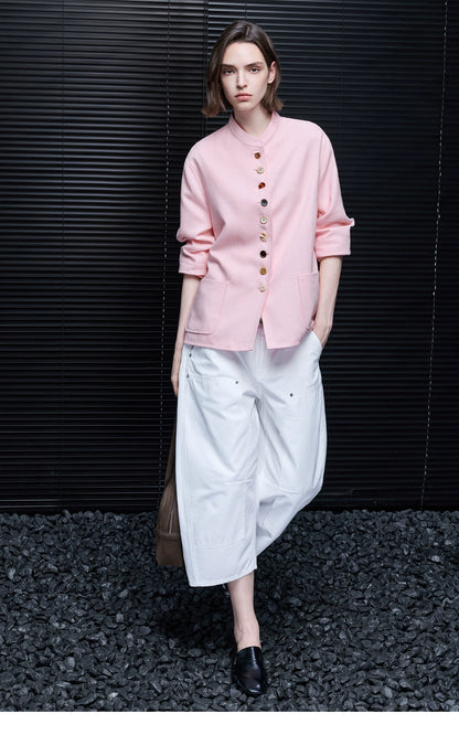 Full-length front view of a Pink linen jacket buttoned up with pushed-up sleeves and square pockets
