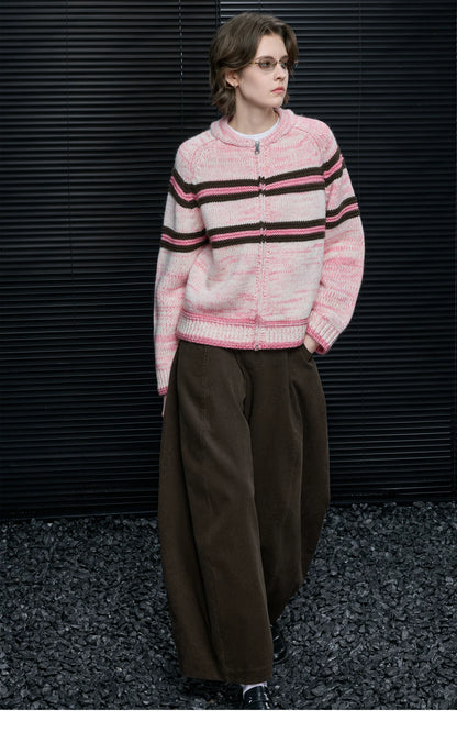 Full-length view of Pink Stripe zip cardigan fully zipped, styled with wide brown corduroy pants
