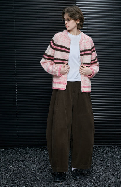 Full-length look of Pink Stripe chunky cardigan worn open with brown corduroy barrel-leg pants and loafers