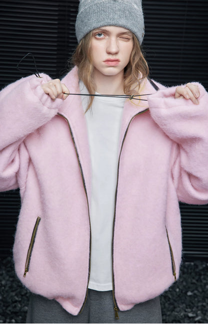 Pink oversized wool-blend jacket worn unzipped, showing the drawcord toggles at the cuffs
