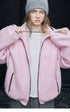 Pink oversized wool-blend jacket worn unzipped, showing the drawcord toggles at the cuffs
