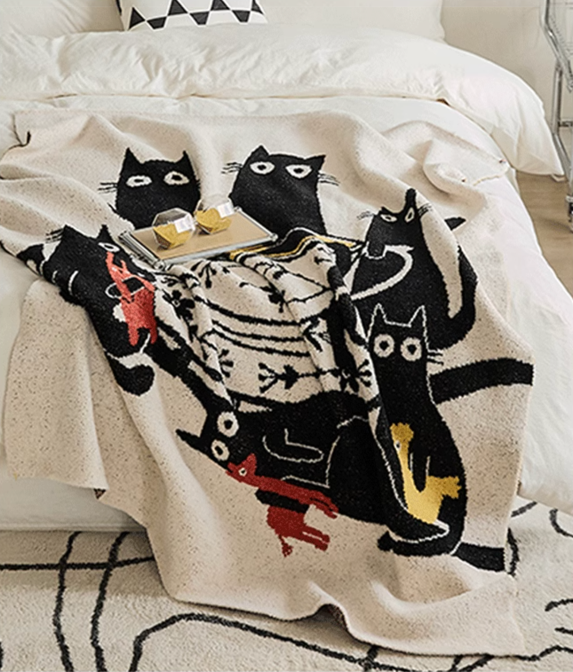 Beige cat tea party blanket arranged on bed with tray showing layered composition of cats and teacup design