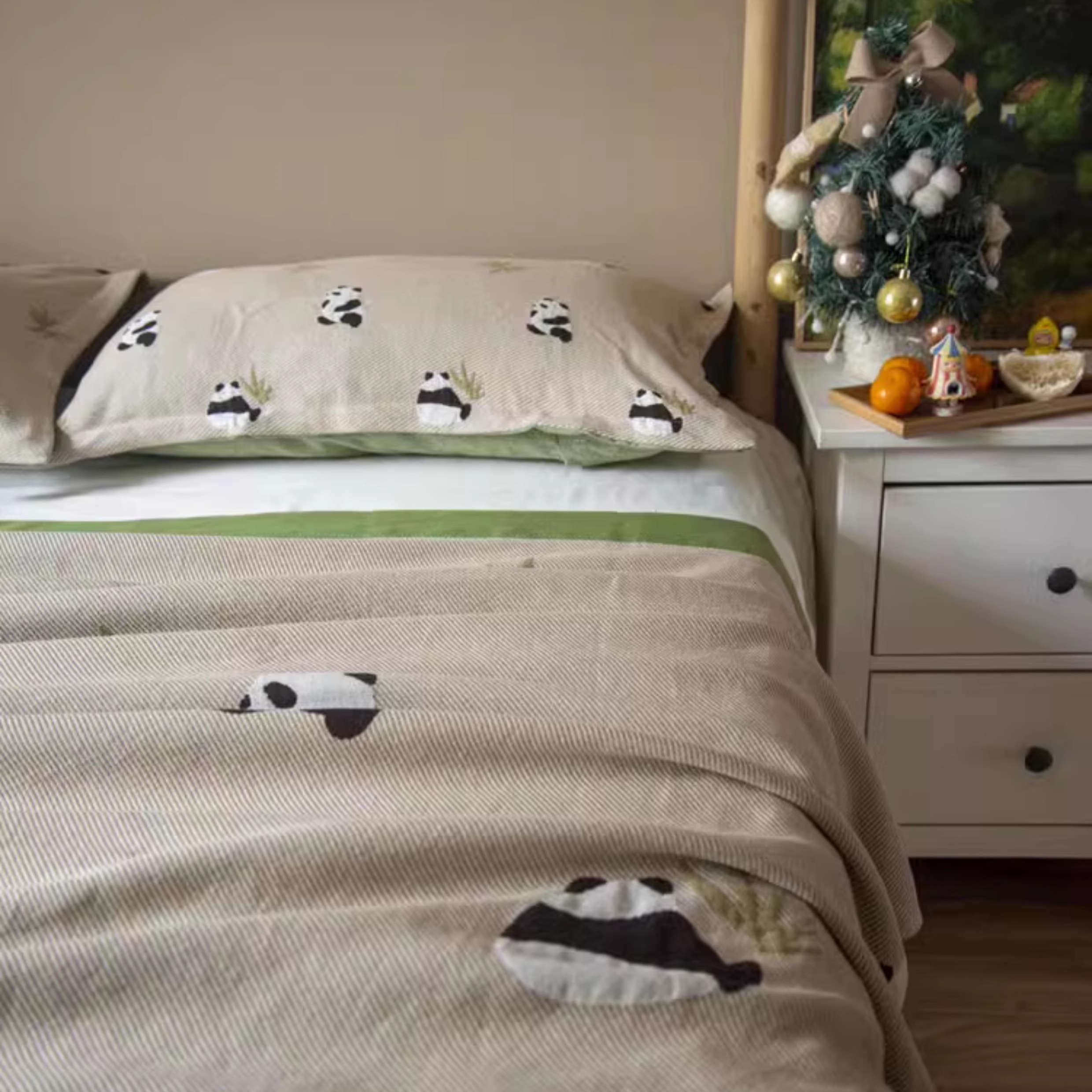 Playful Pals Cotton Gauze Quilted Blanket Panda displayed across a cozy bedroom bed with playful panda design