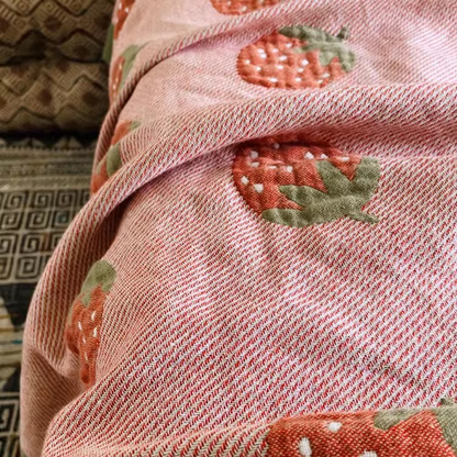 Close-up of Playful Pals Cotton Gauze Quilted Blanket Strawberry showing woven cotton gauze texture and strawberry print