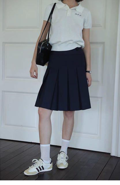 Pleated Chic Skirt navy blue front view highlighting clean pleated design and high-waisted structured fit
