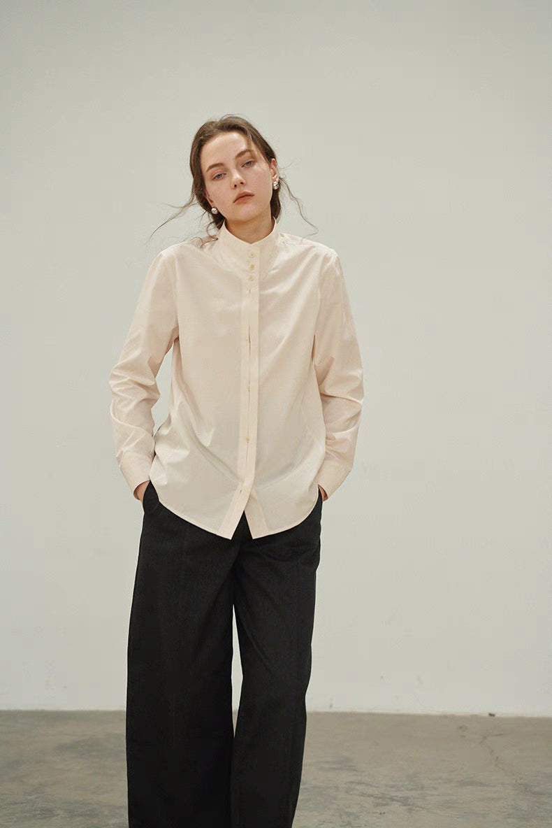 Front full-body view of model wearing Off-White Pleated Placket Stand-Collar Shirt styled with black wide-leg pants, showcasing relaxed fit and elegant pleated front