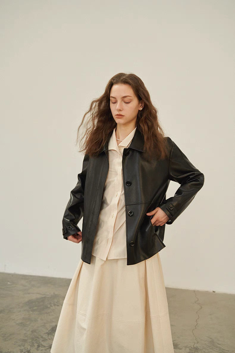 Model wearing Off-White Pleated Placket Stand-Collar Shirt layered under a black leather jacket, styled with skirt for a modern layered outfit