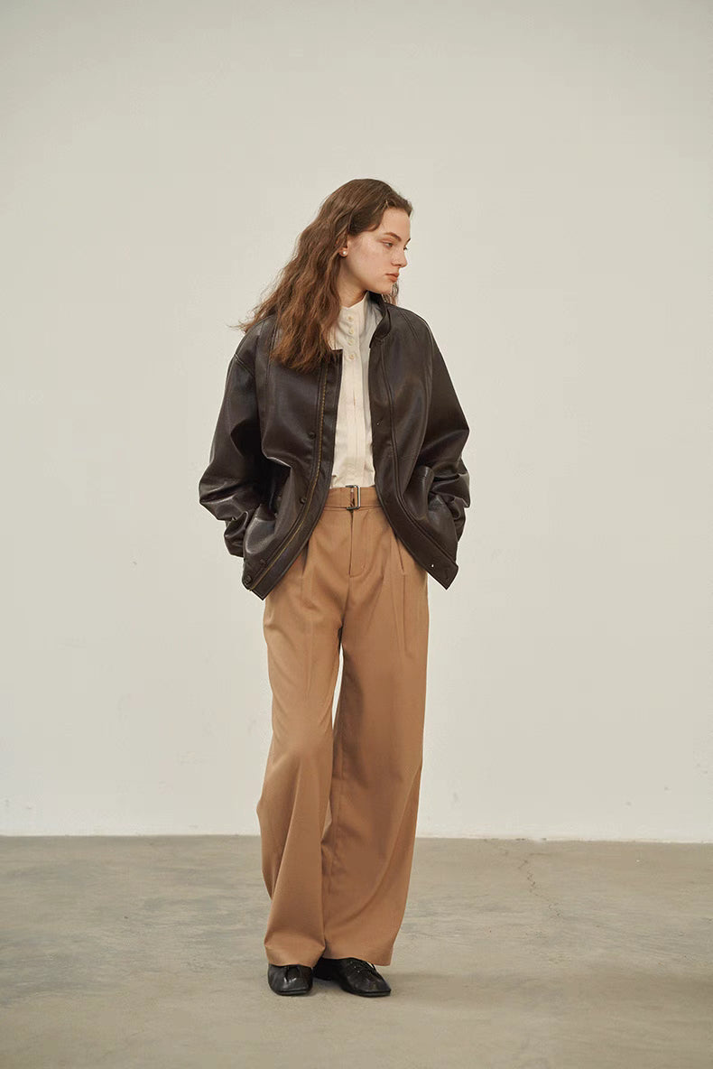 Off-White stand-collar shirt styled under a brown leather jacket with high-waisted wide-leg pants, showcasing versatile layering for fall fashion