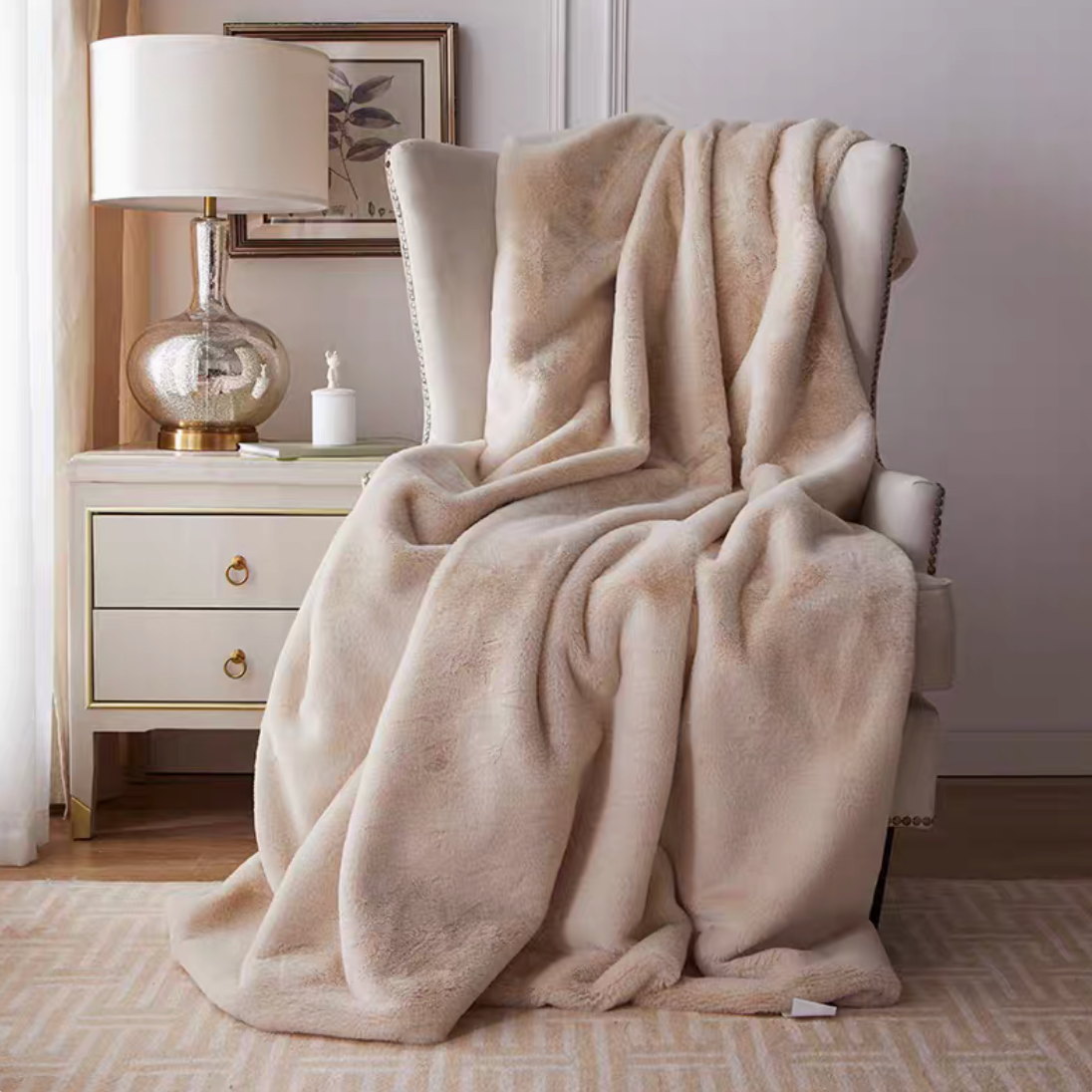 Beige plush reversible faux fur throw blanket draped over armchair in cozy living room setting