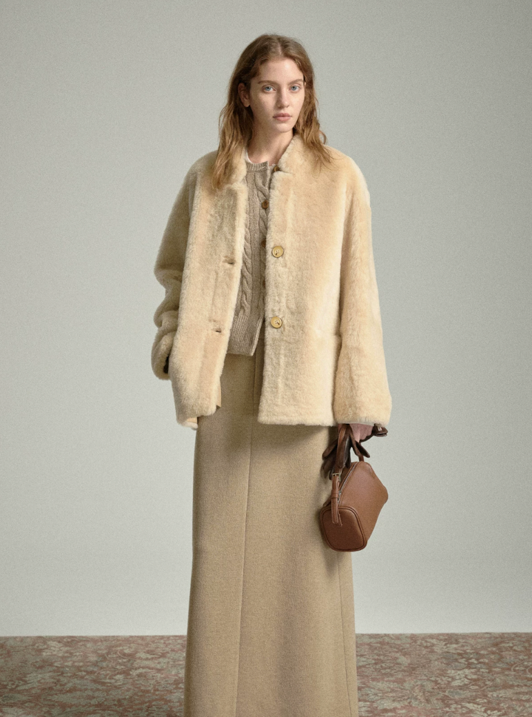 Full-length view of buttoned oat shearling jacket with long knit skirt