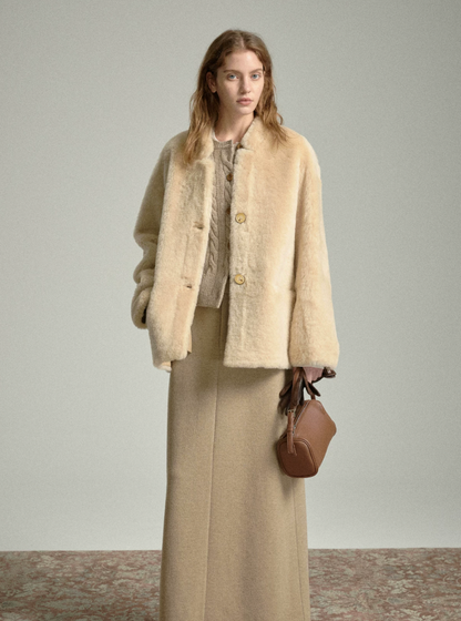 Full-length view of buttoned oat shearling jacket with long knit skirt