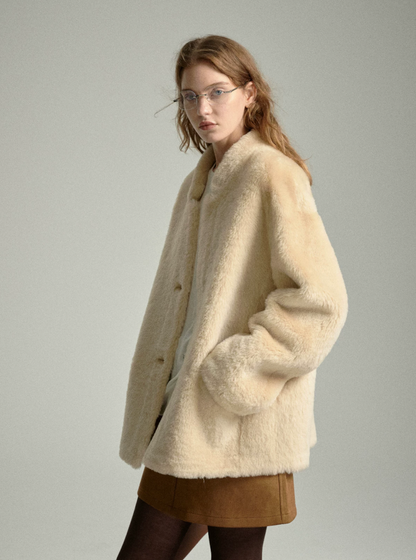 Side view of oat shearling jacket with hands in front pockets