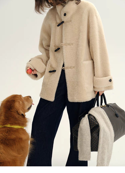 Front detail of Plush Toggle Coat in warm apricot highlighting toggle closures, plush texture, patch pocket, and casual styling with dog