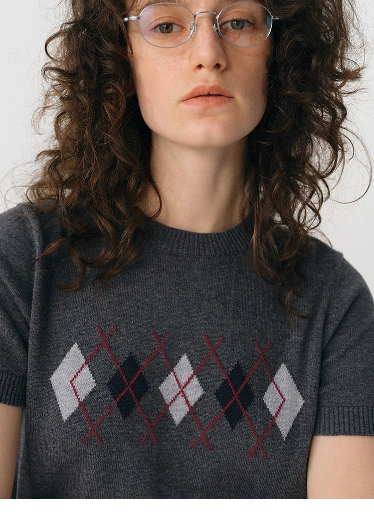 Close-up of charcoal argyle knit tee showing burgundy and gray argyle.