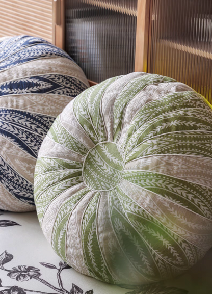 Side view detail of green and blue pumpkin round floor cushions showing textured stitching and pattern