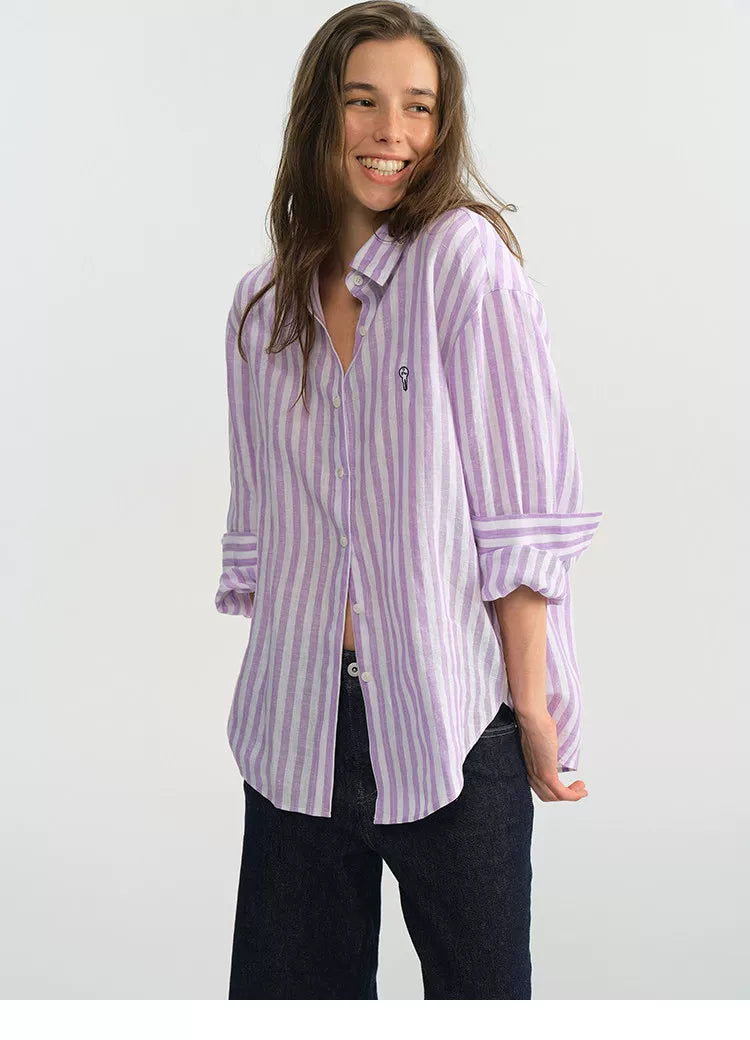 Side profile of purple stripe linen shirt showing embroidered chest logo