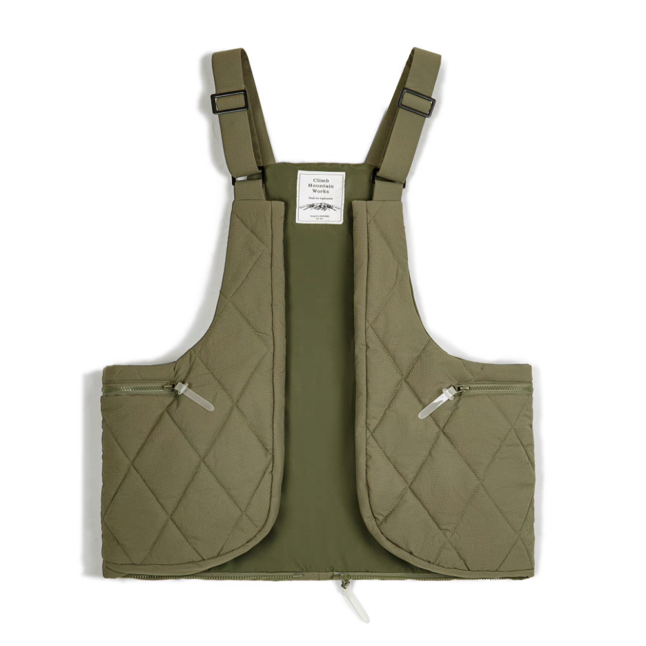 Olive green quilted convertible vest bag front view showing padded diamond stitch texture.
