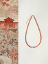 Radiant Sunset Turquoise Choker flat lay featuring vibrant red agate beads with turquoise centerpiece and gold-plated clasp