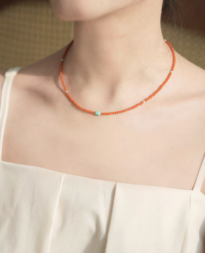 Radiant Sunset Turquoise Choker worn on neck highlighting vivid red agate beads and central turquoise stone