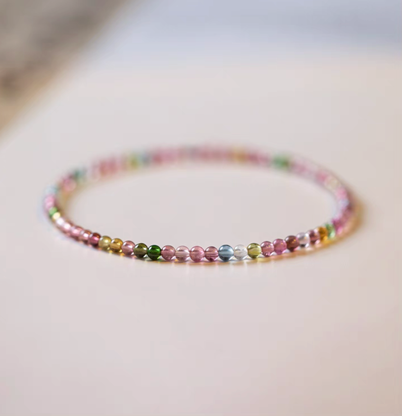 Rainbow tourmaline bead bracelet full circle flat lay showing multicolor stones in minimal setting