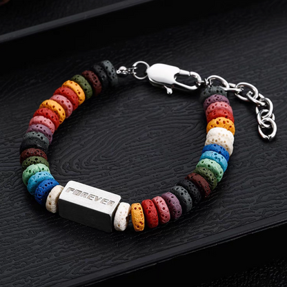Angled view of square bead rainbow lava stone bracelet with engraved titanium steel bar and vibrant multicolor beads