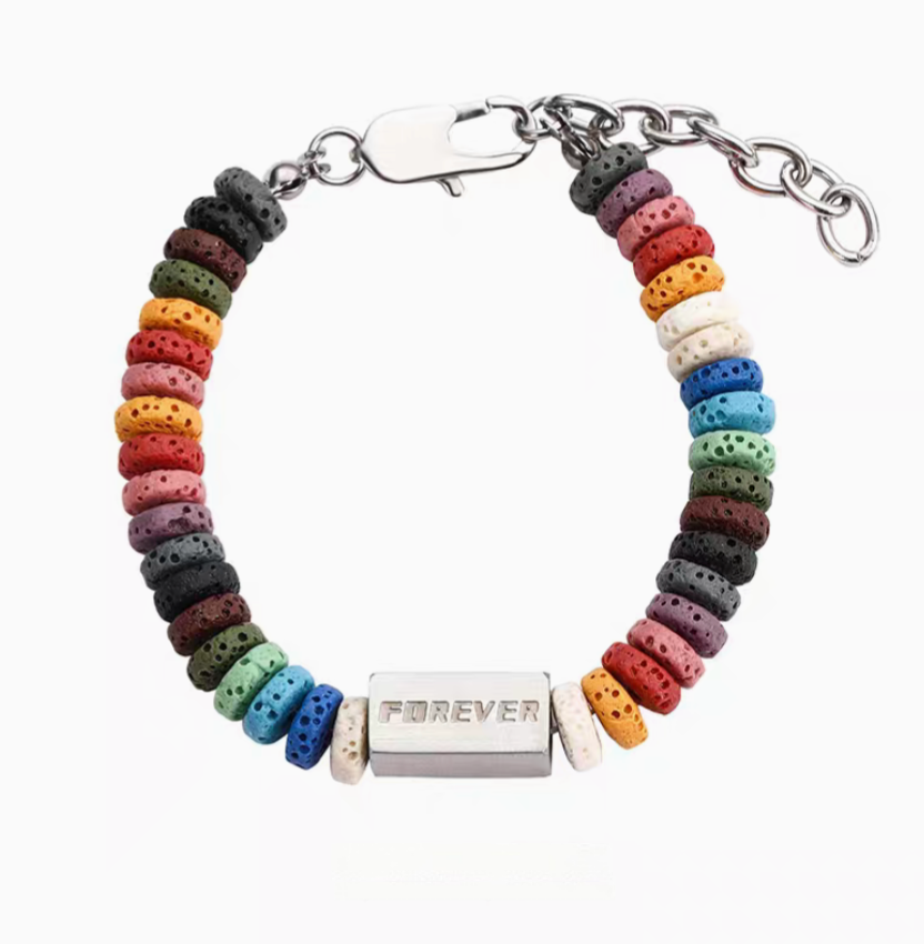 Square bead rainbow volcanic stone bracelet with multicolor lava beads and titanium steel bar centerpiece isolated on white background