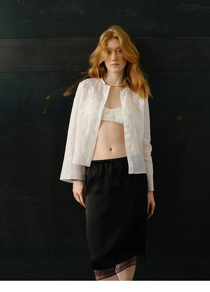Ivory ramie cardigan shirt styled with black lace-trim skirt, front view