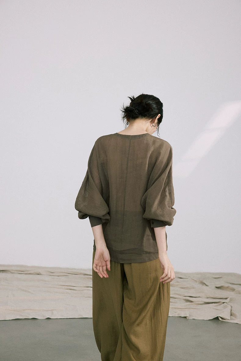 Back view of olive green ramie-Tencel blouse showing balloon sleeve silhouette