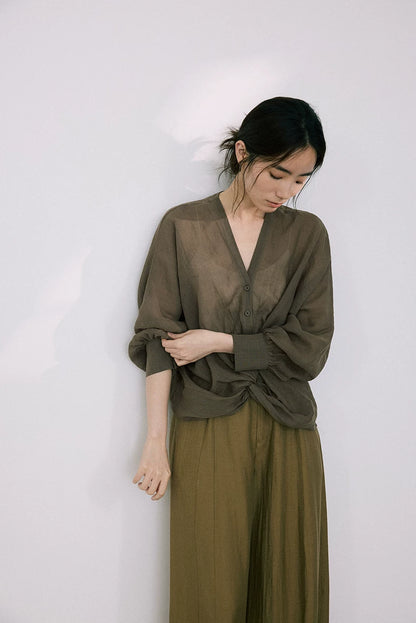 Woman wearing olive green ramie-Tencel blouse with matching wide-leg pants