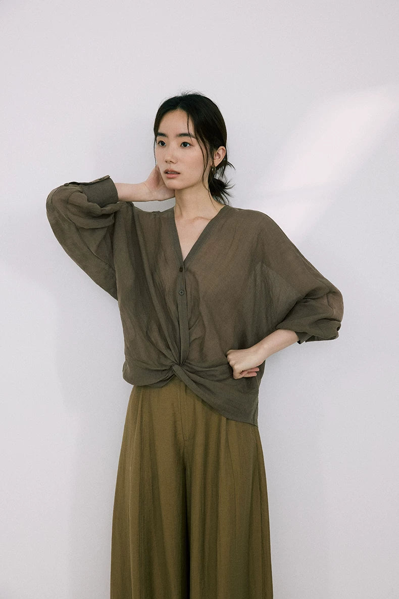 Side view of olive green ramie-Tencel blouse with twist-knot hem detail