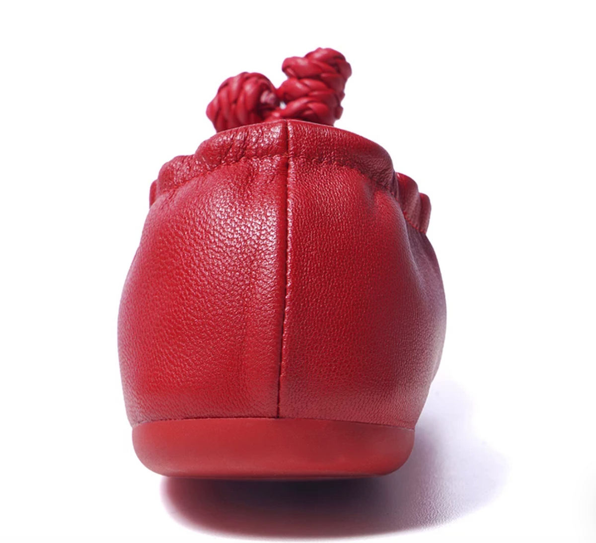 Back view of a red sheepskin ballet flat showing the pebbled leather grain and center heel seam