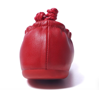 Back view of a red sheepskin ballet flat showing the pebbled leather grain and center heel seam
