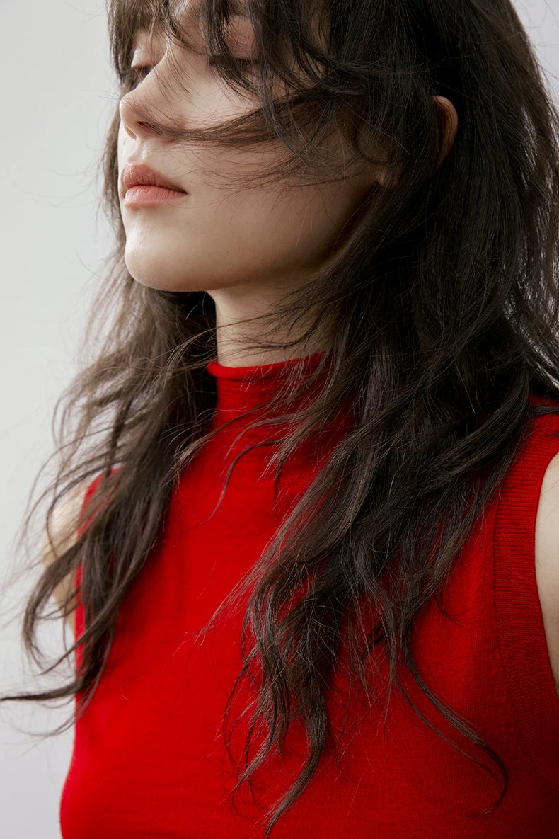 Close-up side profile of Red sleeveless mock neck wool knit top showing fine knit and collar